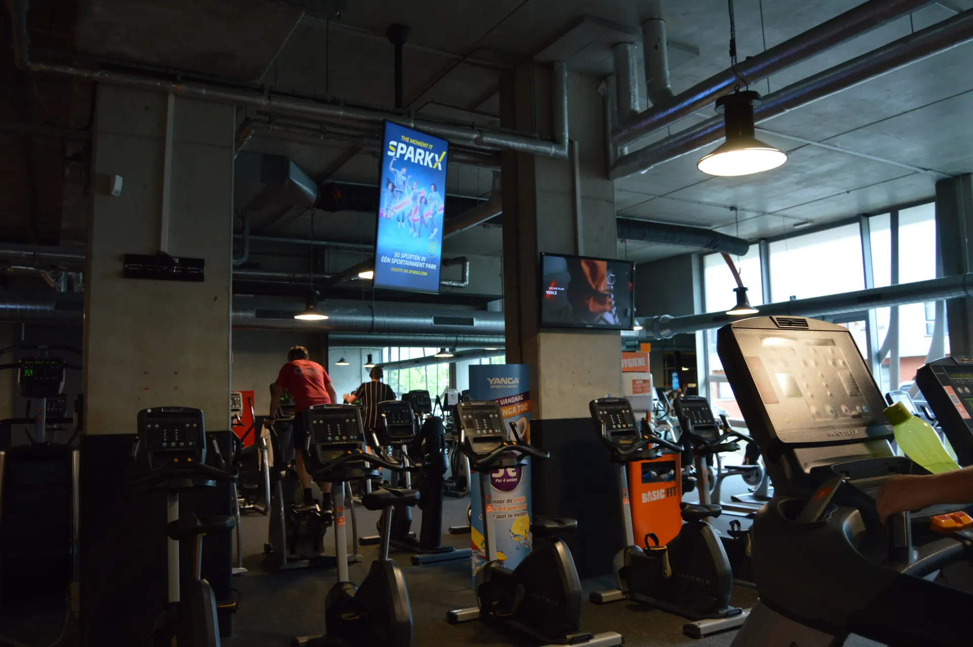 A digital screen inside a venue, playing to the people already in the room